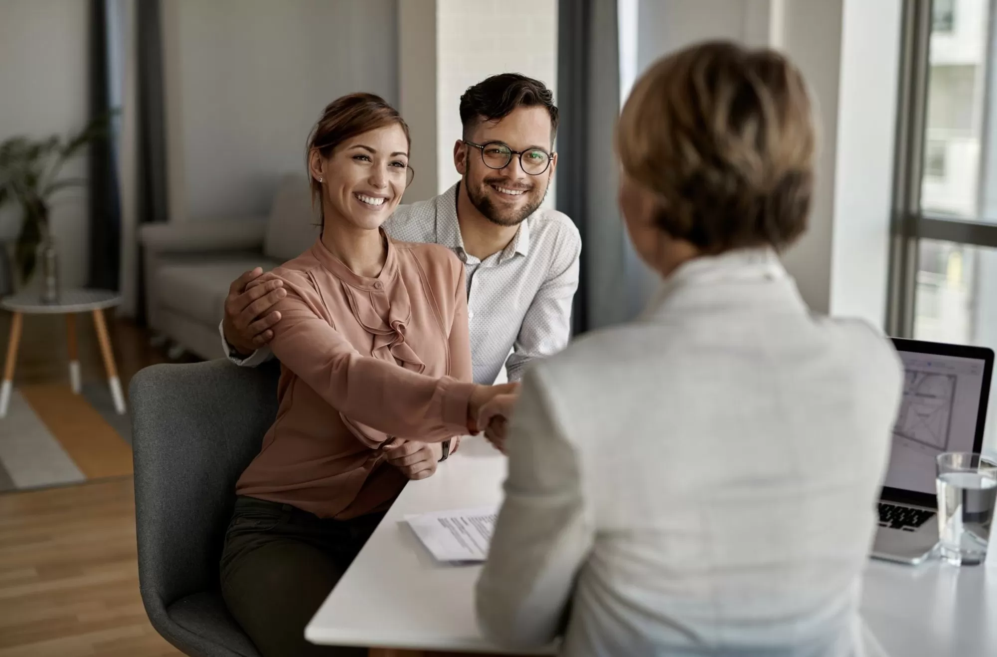 Young happy couple with agent